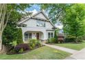 Charming two-story home featuring an arched front porch and beautifully landscaped front yard at 248 Madison Ave, Decatur, GA 30030