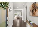 Elegant entryway showcasing hardwood floors, neutral walls, an artwork and views into dining and living areas at 2947 Knob Creek Dr, Snellville, GA 30078