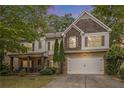 Charming two-story home with brick and shingle accents, well-maintained landscaping and inviting covered front porch at 218 3Rd Ave, Avondale Estates, GA 30002