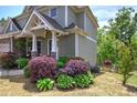 Landscaped front yard with various bushes and greenery enhancing the home's exterior at 544 Pine Way, Dallas, GA 30157