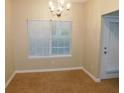 Cozy dining room with tan walls, carpet flooring, and natural light from window at 6991 Bonnes Blvd, Austell, GA 30168