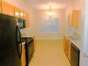 Functional kitchen equipped with modern black appliances and ample cabinet space at 6991 Bonnes Blvd, Austell, GA 30168