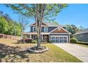 Charming two-story home featuring a welcoming front porch, attached garage and a well-maintained, landscaped front yard at 1699 Boulder Walk Se Dr, Atlanta, GA 30316
