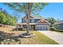 Inviting two-story home with a manicured lawn and classic architectural details at 1699 Boulder Walk Se Dr, Atlanta, GA 30316