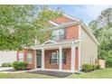 Charming two-story home with brick facade, side yard, and welcoming front porch at 433 Orchid Ln, Canton, GA 30114