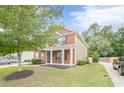 Beautiful two-story home with a well-manicured lawn, brick facade, and inviting front entrance at 433 Orchid Ln, Canton, GA 30114