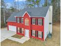 Side angle showing the charming red brick two-story home with white trim and an attached garage at 1029 Chaterly Ct, Riverdale, GA 30296