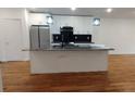Kitchen features granite countertops, stainless steel appliances, island, and white cabinets at 1092 Hillcrest Se Dr, Atlanta, GA 30316
