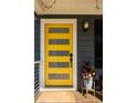 Stylish yellow front door with glass panels, complemented by a potted plant and outdoor lighting at 1608 Terry Mill Se Rd, Atlanta, GA 30316