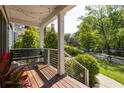 Inviting porch with hanging bench, string lights, and view of the well-maintained yard at 1608 Terry Mill Se Rd, Atlanta, GA 30316