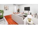 Living room with hardwood floors, modern furniture and decor, and large screen tv at 2965 Pharr Court South Nw # 110, Atlanta, GA 30305