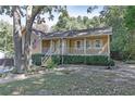 Inviting single-Gathering home showcasing a cozy covered porch and a beautifully landscaped front yard at 304 N Briar Rdg, Woodstock, GA 30189