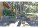 Well-maintained yard and garden landscaping lead to the charming, covered front porch at 304 N Briar Rdg, Woodstock, GA 30189