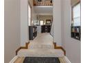 The entryway showcases carpeted stairs, high ceilings, and unique display shelves at 873 Edgewater Cir, Marietta, GA 30062