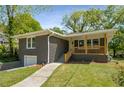 Charming brick home with inviting covered porch and a well-maintained lawn at 2358 Larchwood Sw Rd, Atlanta, GA 30310