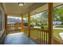 Inviting covered front porch with natural wood columns and railings, offering a cozy outdoor space at 2358 Larchwood Sw Rd, Atlanta, GA 30310