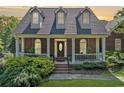 Charming brick home features a welcoming front porch and well-maintained landscaping at 675 Jack Page Ln, Canton, GA 30115