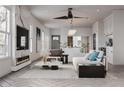 Bright, open-concept living room featuring a fireplace, modern furnishings, and large windows at 995 Sw Sparks St, Atlanta, GA 30310