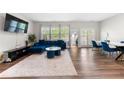 Open living area with stylish blue sectional, wood floors, and dining area at 1025 Cherryfield Run, Marietta, GA 30008