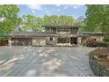 Contemporary home featuring a large driveway, modern architecture, and beautifully maintained landscaping at 1255 Cold Harbor Dr, Roswell, GA 30075