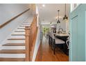 Inviting entryway with hardwood floors, staircase, and an open view into the kitchen and living spaces at 14020 Tributary Ln, Villa Rica, GA 30180