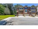Charming brick townhomes feature attached garages, a neatly kept green space, and convenient parking at 3155 Boldmere Se Trl # 3, Smyrna, GA 30080