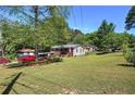 Expansive backyard perfect for outdoor activities, featuring a lush lawn and mature trees at 1001 Rhett Nw Dr, Kennesaw, GA 30144