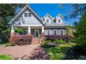 Inviting two-story home with beautifully landscaped yard, covered porch, and classic architectural details at 414 Pensdale Rd, Decatur, GA 30030