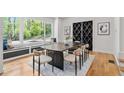 Bright dining room featuring a window seat, a black wine rack, and modern decor at 4366 Skyland Ne Dr, Atlanta, GA 30342