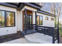 Home front entrance featuring a black door, black framed windows and black porch railing at 4366 Skyland Ne Dr, Atlanta, GA 30342