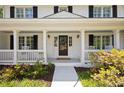 Inviting front porch featuring white railings, columns, and decorative plants at 5040 Winding Branch Dr, Dunwoody, GA 30338