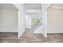 Bright hallway with high ceilings and modern wood-look flooring leading to the staircase at 881 Springs Crest Dr, Dallas, GA 30157