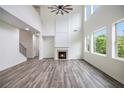 Cozy living room featuring a fireplace, high ceilings, many windows, and hardwood floors at 881 Springs Crest Dr, Dallas, GA 30157