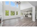 Bright, open living space with fireplace, hardwood floors, and expansive windows with view of greenery at 881 Springs Crest Dr, Dallas, GA 30157