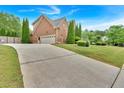 Long driveway leading to a brick home with a two-car garage at 900 Fox Croft Pl, Canton, GA 30114