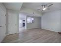 Bright living room with ceiling fan, wood-look flooring, and an open view to the kitchen at 2528 Mulberry Rock Rd, Dallas, GA 30157