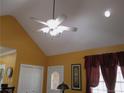 A vaulted ceiling with a ceiling fan above a room with orange walls and white trim on doors and windows at 28 County Line #2 Rd, Rydal, GA 30171