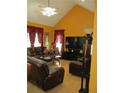 Comfortable living room with vaulted ceilings, a ceiling fan, a flat screen tv, and leather furniture at 28 County Line #2 Rd, Rydal, GA 30171
