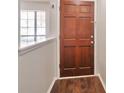 View of the entryway featuring wood flooring, a solid wood door, fresh neutral paint, and natural light at 814 Arbor Hill Dr, Stone Mountain, GA 30088
