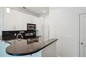 Well-lit kitchen featuring white cabinets, granite countertops, and stainless steel appliances at 221 Semel Nw Cir # 245, Atlanta, GA 30309