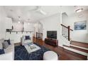 Bright living room featuring hardwood floors, a comfortable sofa, and a modern ceiling fan at 221 Semel Nw Cir # 245, Atlanta, GA 30309