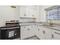Modern kitchen with white cabinets, granite countertops, and stainless steel appliances at 300 Peachtree Ne St # 5A, Atlanta, GA 30308