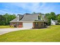 A lovely brick home boasting an attached garage and well-kept landscaping at 330 Pitts Chapel Rd, Newborn, GA 30056
