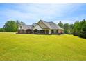 Beautiful single story brick home with attached garage, and sprawling green lawn at 330 Pitts Chapel Rd, Newborn, GA 30056
