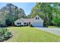 Charming one story home featuring an attached garage and a well maintained lawn and landscape at 4735 Rabbit Farm Rd, Loganville, GA 30052