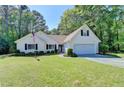 Charming one story home featuring an attached garage and a well maintained lawn and landscape at 4735 Rabbit Farm Rd, Loganville, GA 30052