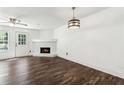 Spacious living room featuring modern hardwood floors, a fireplace, and natural light from windows at 215 Morris Ln, Woodstock, GA 30188