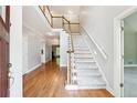 Bright foyer with hardwood floors, staircase, and high ceilings create a grand entrance at 936 Bramble Oak Ct, Powder Springs, GA 30127