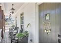 Inviting covered porch with rocking chairs, decorative lanterns, and a charming wreath on the front door at 123 Cricket Ln, Alpharetta, GA 30009