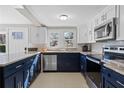 Well-lit kitchen featuring stainless appliances, granite counters, and ample storage at 3595 South Nw St, Duluth, GA 30096